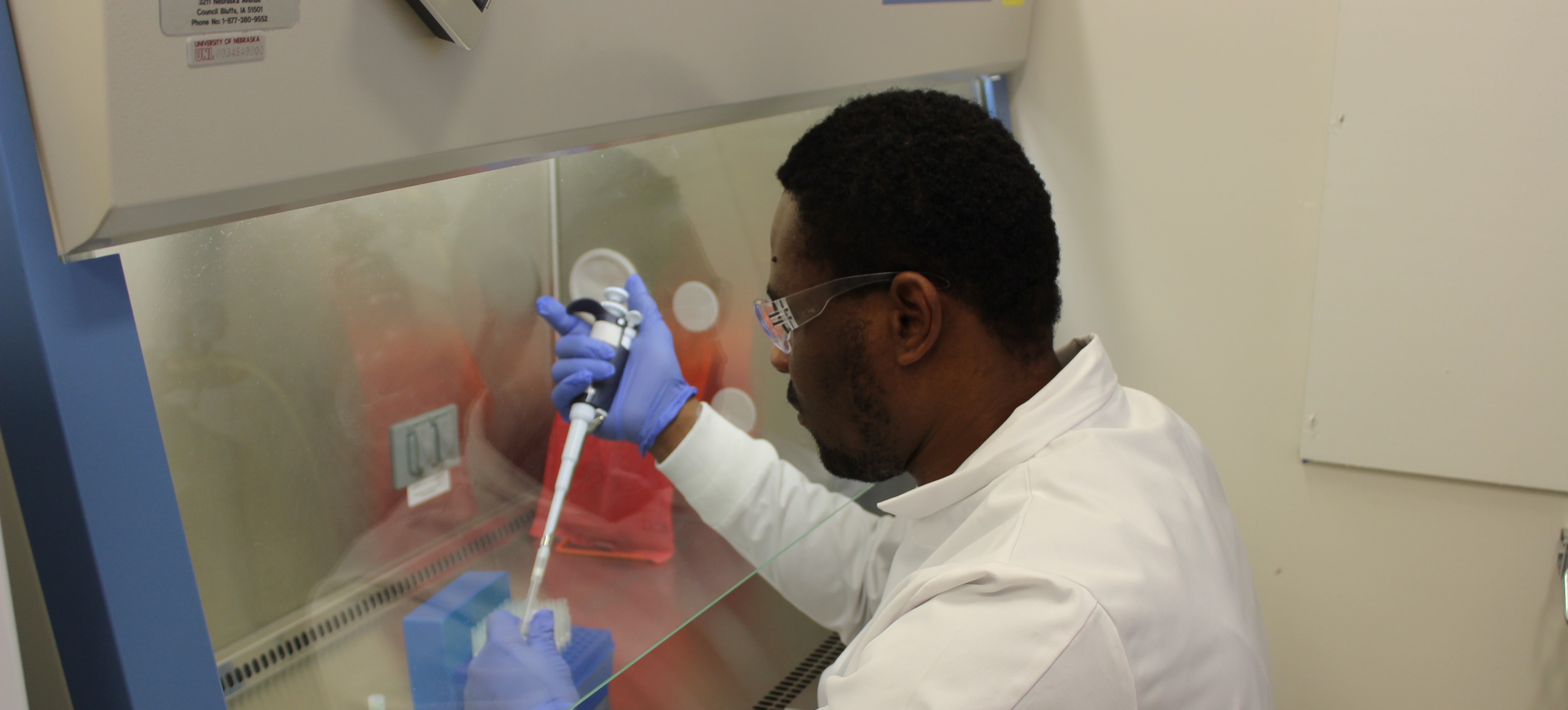 Graduate Student working with a machine in the clinic lab. 