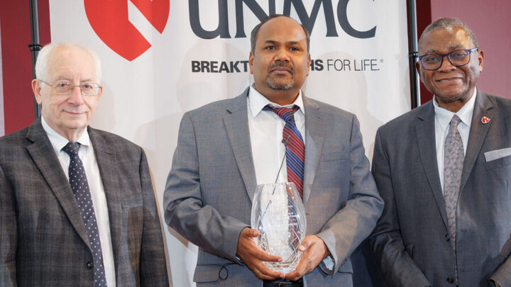 Siddappa Byrareddy, PhD, center, with UNMC College of Medicine Dean Brad Britigan, MD, at left and UNMC Interim Chancellor Dele Davies, MD, at right