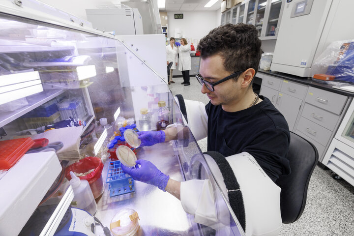 Laboratory image for the Gnoto Facility. A scientist is working within an anerobic chamber.